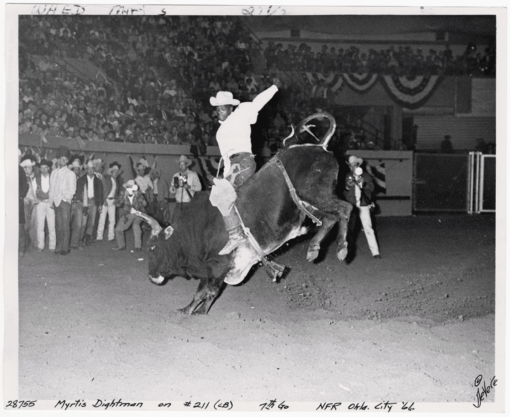 Myrtis Dightman is riding a bull at the National Finals Rodeo in Oklahoma City in 1966. 